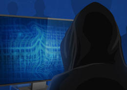 Hacker in black hoodie sitting in front of computer screen