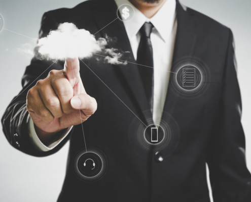Man in a business suit using the cloud for storage, data, shopping, etc.