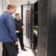Sovran employee showing a man the server room.