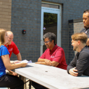 Sovran’s help desk team discussing a client issue outside of the facility.