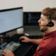 Sovran team member at PC work station with Mac device in the background.