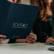 A woman holding a folder about technological solutions for businesses.
