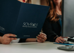 A woman holding a folder about technological solutions for businesses.