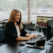 A female office worker typing on her computer.