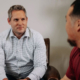 Two businessmen talking in an office.