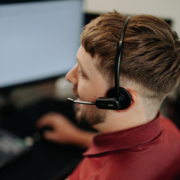 An IT Help Desk worker talking on a headset.