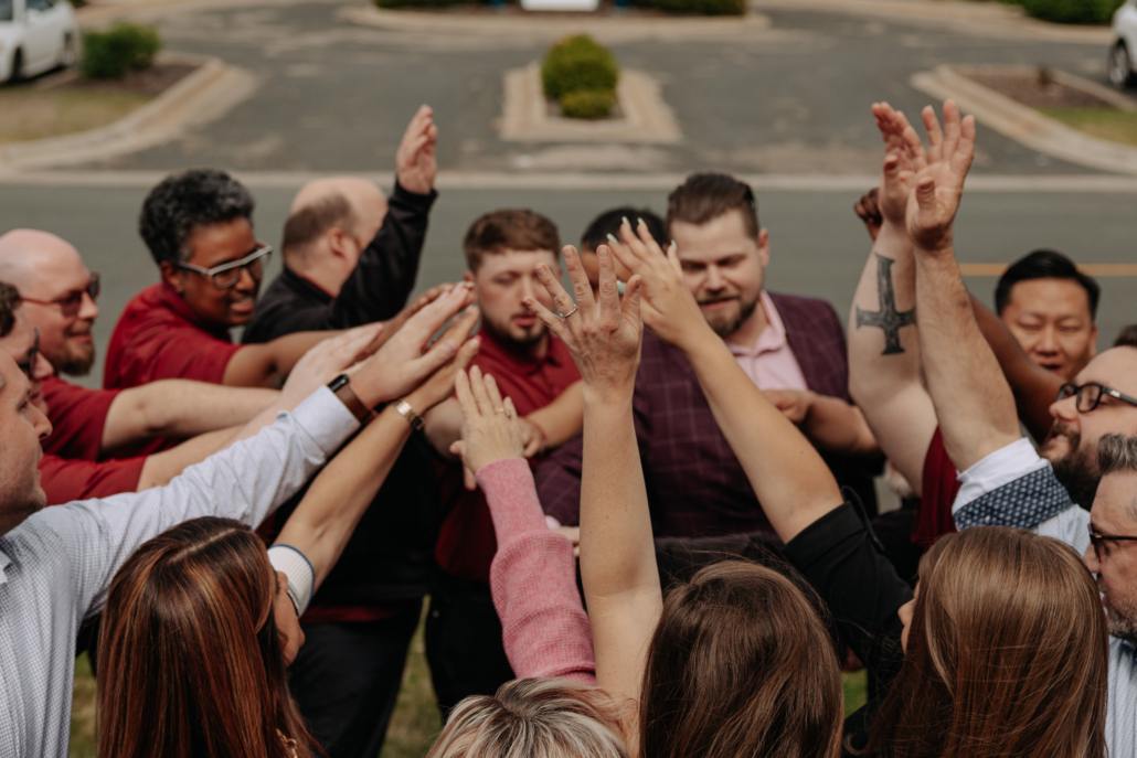A team of employees breaking a huddle.