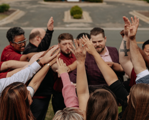 A team of employees breaking a huddle.