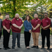 A team of office workers posing for a picture.